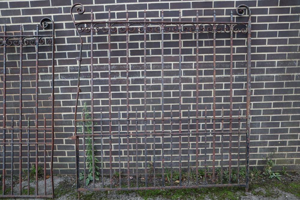A pair of wrought iron gates, each gate 177cm wide, 193cm high